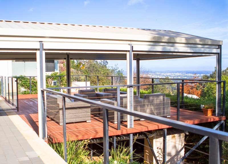 a deck with a metal railing and a bench Armadale Patio